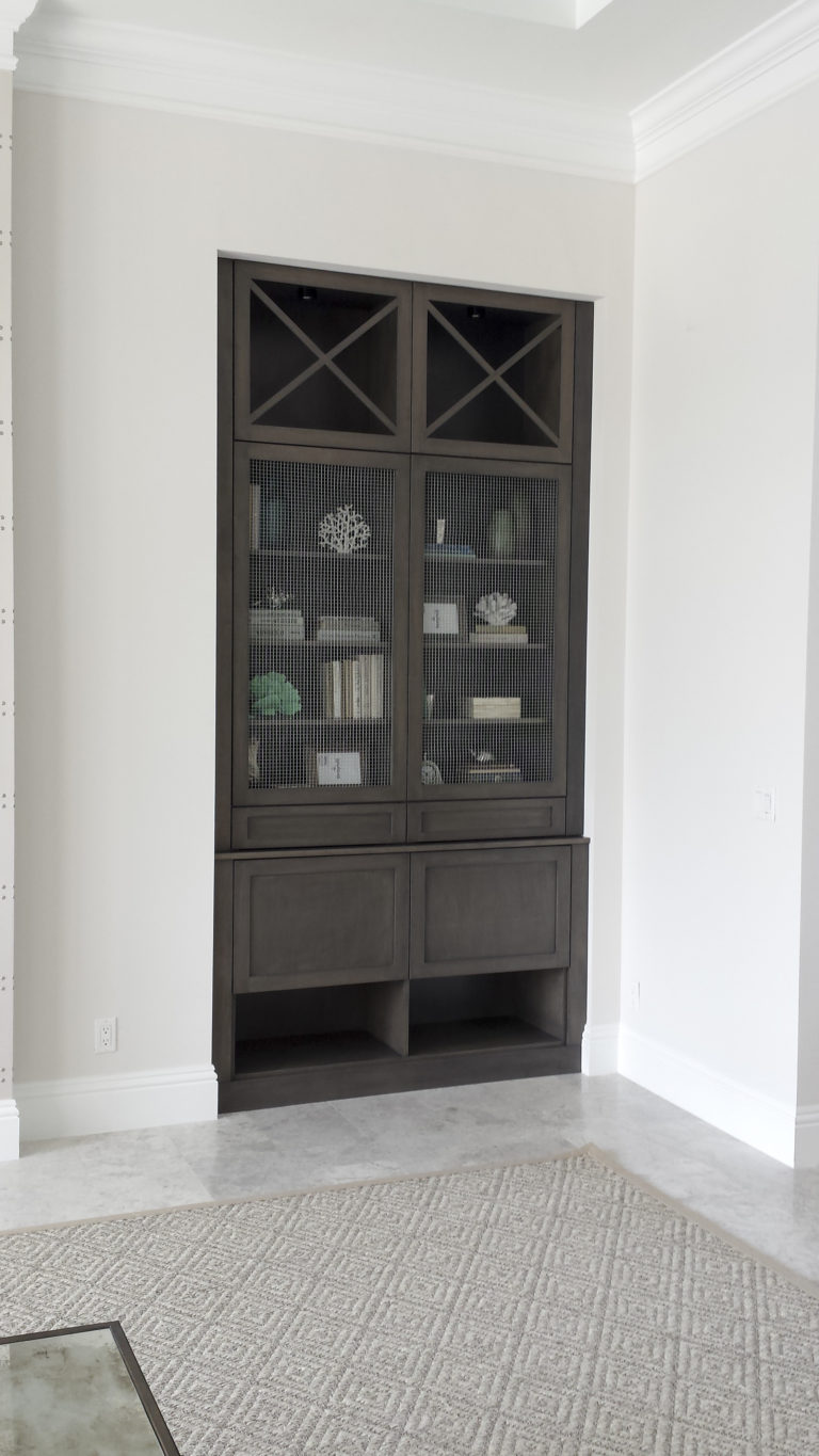 custom built-in book shelving with decorative doors