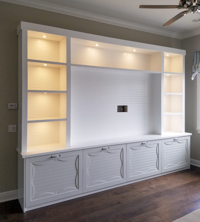 white wall unit with custom cabinet lighting